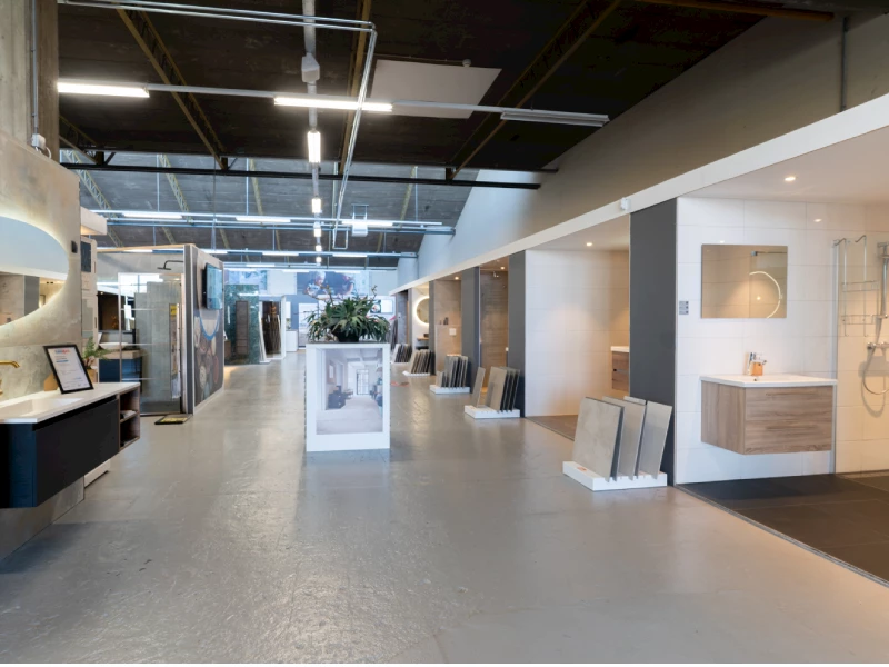 Interieur van de Sani4All badkamerwinkel in Vianen met badkamerdisplays en tegelstalen